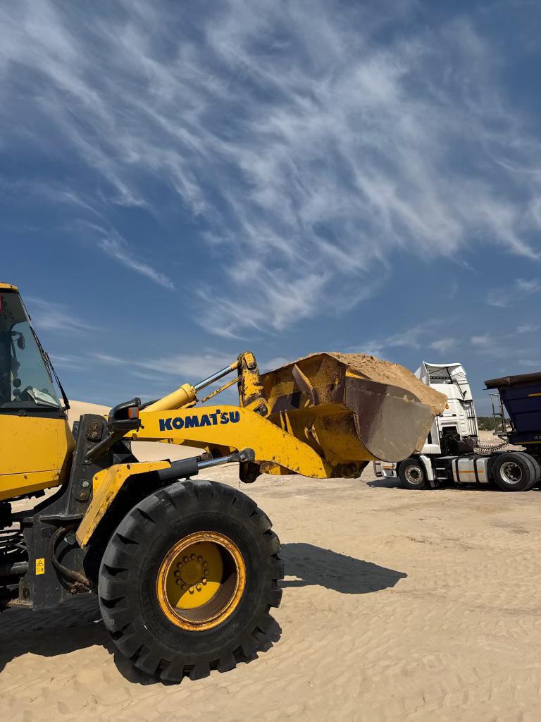 Komatsu front-end loader loading aggregate at a quarry site